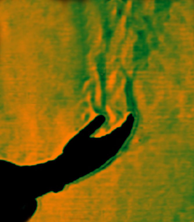 Thermal plume of air rising as a result of a warm hand being surrounded by cooler air is an example of natural convection