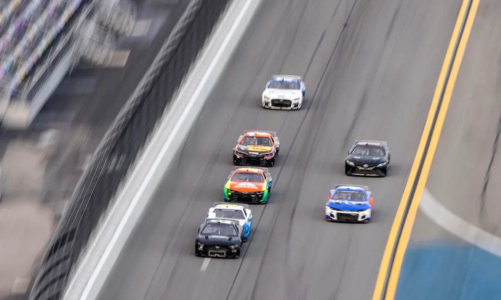 NASCAR race cars on a straightaway engaging in drafting