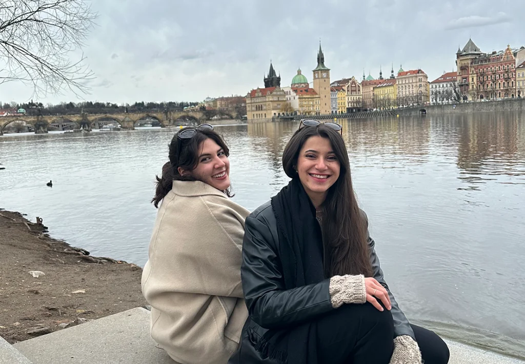 Fillia and Sila sitting along a river