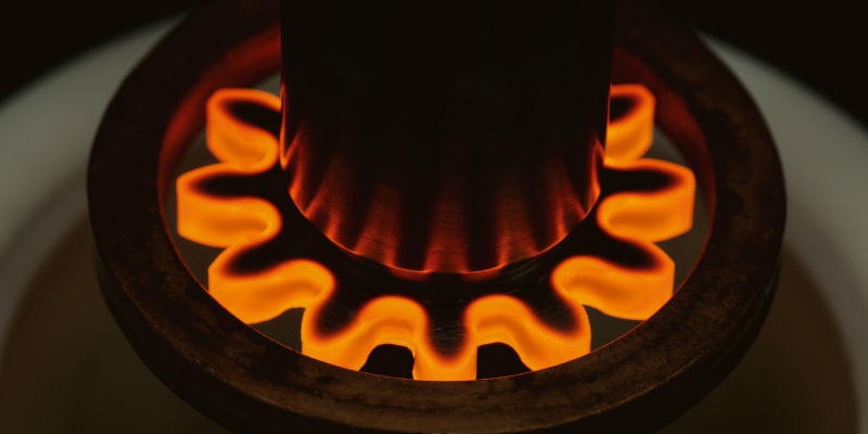 Induction hardening in progress with the outer metal being red hot